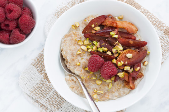 oatmeal with baked fruit for breakfast, closeup, top view