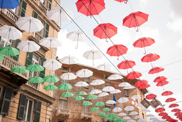 Fototapeta na wymiar Genoa, old town: colored umbrellas decorating urban landscape (event: Euroflora 2018) 
