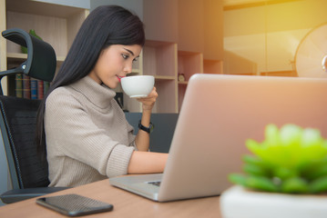 business woman holding a cup of coffee with happy relaxed in office
