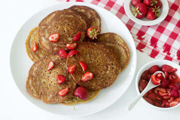Useful breakfast of pancakes with linseed flour and strawberry-honey sauce.