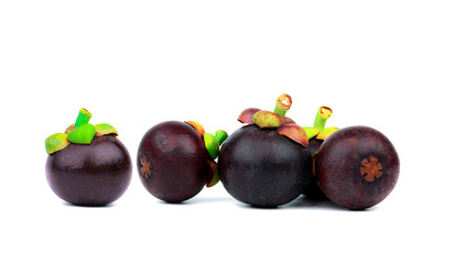 Whole mangosteen showing purple skin isolated on white background with space. Tropical fruit from Thailand. The queen of fruits. Asia fresh fruit market concept. Natural source of tannin and xanthones