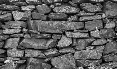 Old wall in country side in Black and White. Old wall texture. Wall texture and background. Stones background. Abstract texture and background for designers. Closeup view of rock wall and stones.