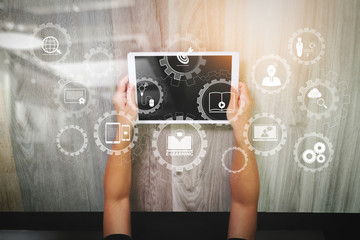 top view of Designer hand working with digital tablet computer on wooden desk as responsive web design concept