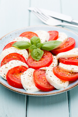 Classic caprese salad. Mozzarella tomatoes and  Basilikum.