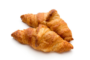 Tasty buttery croissants on the white background.