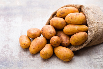 A bio russet potato wooden vintage background.