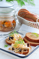 Marinated herring and onion on rye bread, selective focus