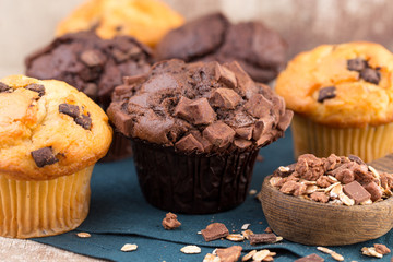 Homemade muffins with chocolate, vintage background.