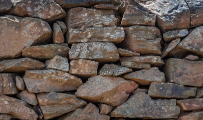 Old wall in country side. Old wall texture. Wall texture and background. Stones background. Abstract texture and background for designers. Closeup view of rock wall and stones.