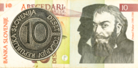 10 slovenian tolar coin against 10 slovenian tolar banknote obverse