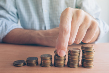 Finances and budgeting, businessman stacking coins