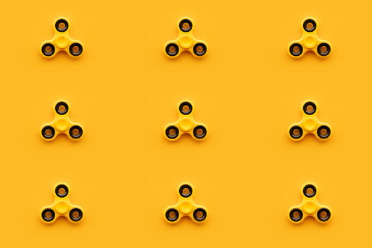 Seamless pattern background of yellow fidget spinner toy