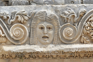 Ancient stone masks of the amphitheater in Myra. Demre, Turkey