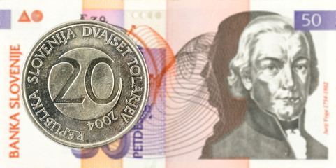 20 slovenian tolar coin against 50 slovenian tolar banknote obverse