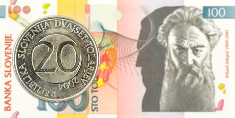 20 slovenian tolar coin against 100 slovenian tolar banknote obverse