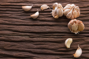 Garlic cloves on wooden vintage background.