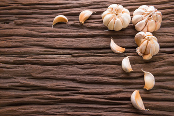 Garlic cloves on wooden vintage background.
