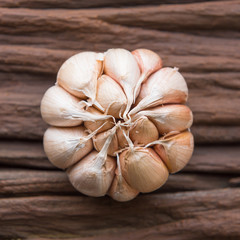 Garlic cloves on wooden vintage background.