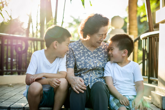 Happy Senior Asian Woman Talking With Her Grandchildren