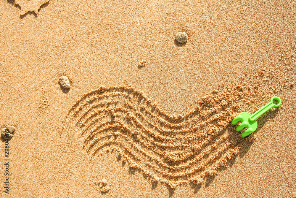 Wall mural beautiful drawing on the sand of the sea background