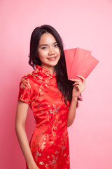 Cute Asian girl in chinese red cheongsam dress with red envelope