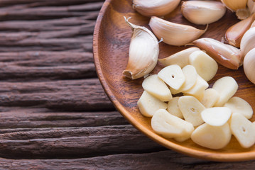Garlic cloves on wooden vintage background.