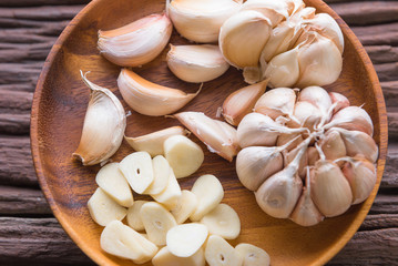 Garlic cloves on wooden vintage background.