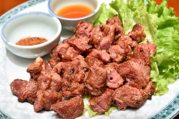 Delicious roasted lamb ribs with cumin and sauce on the white plate