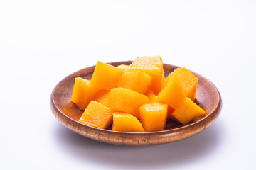Fresh and beautiful mango in a wooden plate with sliced diced mango chunks isolated with   white background, copy space(text space), blank for text