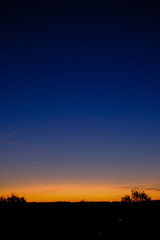 dramatic sunrise over the calm country side trees