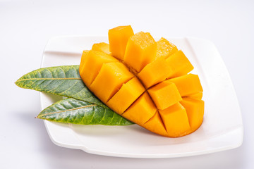 Fresh and beautiful mango in a white plate with sliced diced mango chunks isolated with   white background, copy space(text space), blank for text