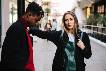 assertive woman with introverted man in the city