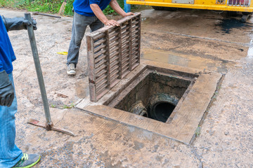 Working for drain cleaning. Problem with the drainage system.
worker with cleaning truck pumps out the dredging drain tunnel cleaning sewage in city street.