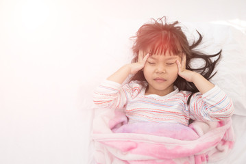 Obraz na płótnie Canvas Children headache. Little girl lying in the bed