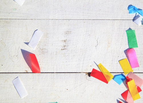 Multicolored Confetti On The White Painted Wooden Floor Or Table Background