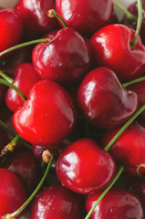 Background from fresh ripe red cherries with water drops. Toned.