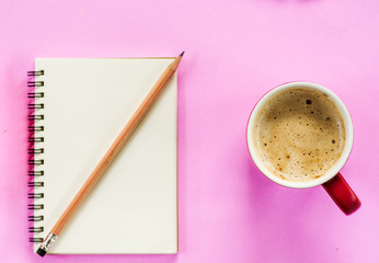 Bank book with pencil and coffee cup on pink background, morning desk office concept