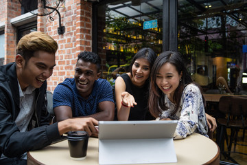 a group of multi culture friends discussing work at cafe