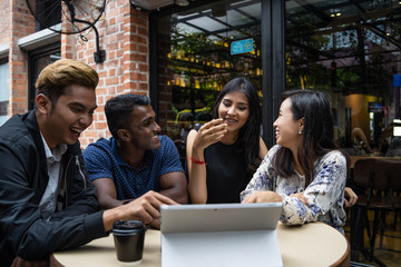 a group of multi culture friends discussing work at cafe