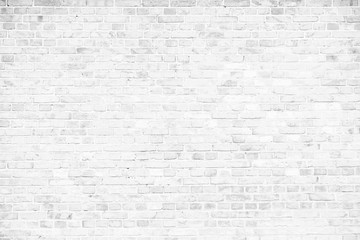 Simple grungy white brick wall as seamless pattern texture background.