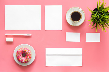 Come up with brand identity. Blank stationery for branding near coffee and donut on pink background top view mockup pattern