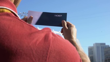 Happy man kissing football ticket, lucky lottery winner, excited before match