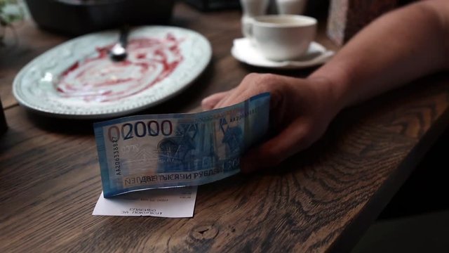 Empty Cup Of Black Coffee On Table And Russian Banknotes With Cosmodrome Vostochny On It