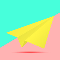 yellow paper plane icon with shadow on pink and blue background. fashion flat lay concept