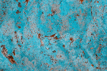 Blue cyan color facade stone wall with imperfections, holes and cracks as an empty rustic and simple texture background.