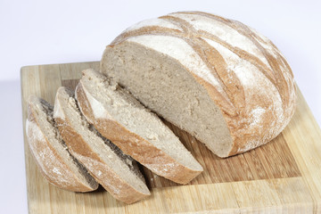 fresh bread on wooden board isolated on white