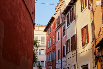 Fototapeta na wymiar Beautiful buildings standing on narrow street on sunny day in Rome, Italy