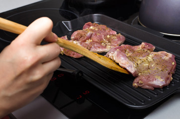 Raw turkey meat on the cooking pan. Preparation of grilled meat.