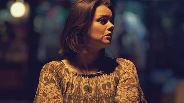 Woman alone at night on street in city scared
