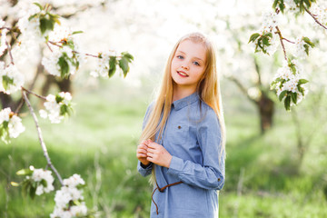 Beautiful teen girl in a blooming garden.